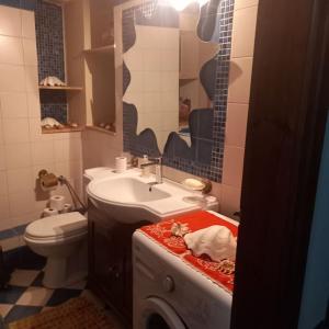 a bathroom with a sink and a toilet at Παραδοσιακό πέτρινο σπίτι in Volissos