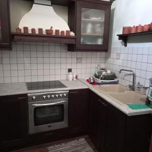 a kitchen with a sink and a stove top oven at Παραδοσιακό πέτρινο σπίτι in Volissos