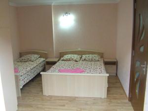 a small bedroom with two beds in it at Chicho Guesthouse in Borjomi +22 photos
