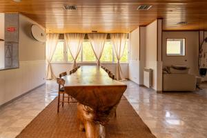 a large wooden table in the middle of a room at Lisbon Surf Hostel in Carcavelos