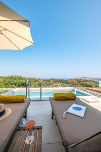 a room with a view of a swimming pool at Evora Suites in Chania Town