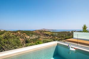 a swimming pool with a swan sitting on top of it at Evora Suites in Chania Town
