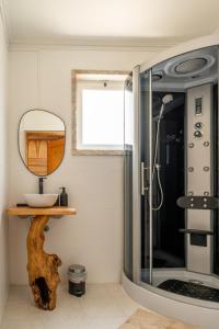 a bathroom with a mirror and a shower at Lisbon Surf Hostel in Carcavelos