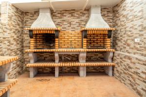 a room with wooden shelves in a brick wall at Lisbon Surf Hostel in Carcavelos