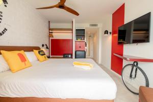 a bedroom with a white bed with a bicycle on it at Ryans Lolas - Adults Only in San Antonio Bay