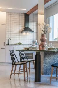 a kitchen with a table and chairs in a kitchen at Balcon del Centro in Vigo