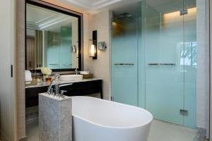 a bathroom with a tub and a sink and a shower at InterContinental Phuket Resort by IHG in Kamala Beach