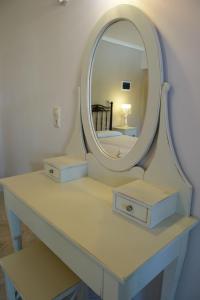 a dressing table with a mirror on top of it at Akrogiali Studios in Nydri