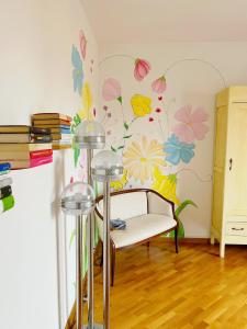 un soggiorno con un murale floreale sul muro di One More Page House - Per un soggiorno da Favola a Certaldo
