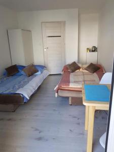 En eller flere senge i et værelse på Udany-Pobyt