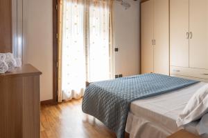 a bedroom with a bed and a large window at IseoLakeRental - La Magia del Lago in Ranzanico