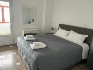 a bedroom with a bed with two towels on it at Aroma Cavas in Pirgos