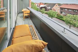a balcony with two beds and a view of a city at Lüttjeod Apartmentvilla Lüttjeod Apartmentvilla 18 in Langeoog