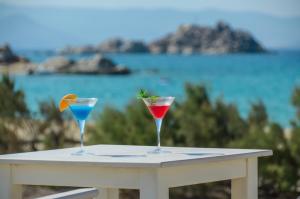 two cocktails sitting on a table with a view of the ocean at Victoria Studios & Apartments in Mikri Vigla