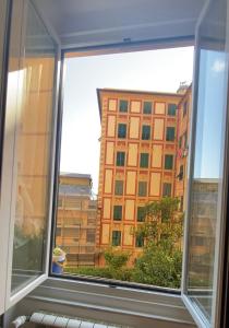 a window with a view of a large building at Soffio Di Mare in Camogli