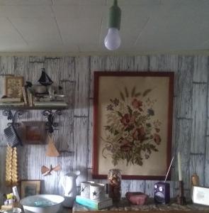 a kitchen with a painting on the wall at Sjöstugan Bodarna Hedemora in Hedemora
