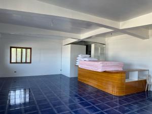 a room with a bed and a table in it at Puraran Surf Beach Resort in Baras