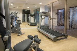 a gym with three tread machines in a room at Hotel Arkadia Jelcz-Laskowice in Jelcz-Laskowice