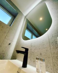 a bathroom with a sink and a mirror at 3C Boutique Apartments Nrº14 in Mainburg