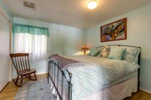 a bedroom with a bed and a chair and a window at Lakefront Connecticut Retreat Near UConn in Coventry