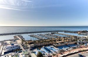 una vista aérea de un puerto deportivo con barcos en Leonardo Hotel Fuengirola Costa del Sol, en Fuengirola