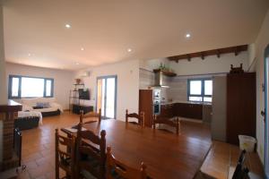 a living room with a wooden table and a kitchen at RA694 Casa con piscina de 4 dormitorios in Cuevas del Almanzora