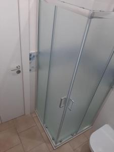 a glass shower in a bathroom with a toilet at Casa vacanze Gemini in Triscina