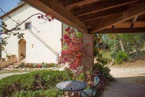 a patio with a table and chairs and a building at Agriturismo Morani in Santa Severa