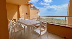 a table and chairs on a balcony with a view at Golf Mar II F 2-4 in Pals