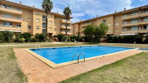a swimming pool in front of a building at Golf Mar II F 2-4 in Pals