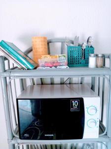 a shelf with a microwave on top of it at La Chambre bleue in Libreville +12 photos