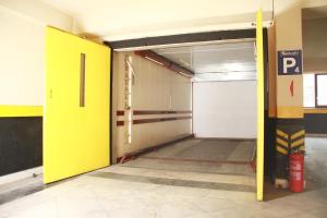 an empty parking garage with a yellow door at Oglakcioglu Park Boutique Hotel in İzmir