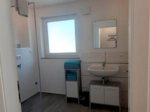a bathroom with a sink and a window at Dorfglück Oberdigisheim in Meßstetten