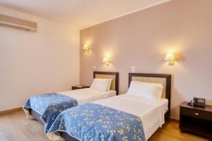 Postel nebo postele na pokoji v ubytování Oscar Hotel