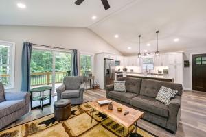 a living room with two couches and a table at Creekside Cabin in Franklin about 8 Mi to Downtown! in Franklin
