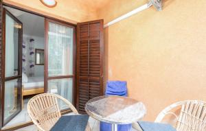 a patio with a table and chairs and a window at Rudel Room with Terrace in Fažana +5 photos