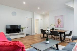 a living room with a table and a tv at Luxury living - Central Hobart/free parking in Hobart