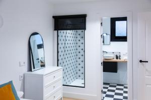 a bathroom with a mirror and a sink at Exclusivo Loft Catedral in Almería +22 photos