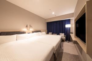Postel nebo postele na pokoji v ubytování Hotel Keihan Nagoya