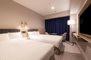 Postel nebo postele na pokoji v ubytování Hotel Keihan Nagoya