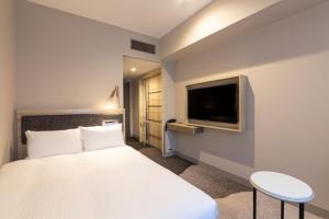 Postel nebo postele na pokoji v ubytování Hotel Keihan Nagoya