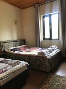 a bedroom with two beds and a window at Legenda Health Resort in Kaji-Say
