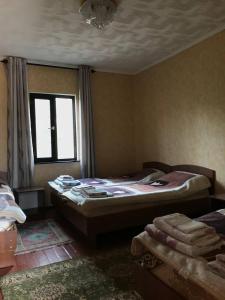 a bedroom with two beds and a window at Legenda Health Resort in Kaji-Say