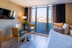 a hotel room with a table and a room with a view at Hotel Plaza in A Coruña