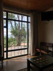 a living room with a large window and a table at Legenda Health Resort in Kaji-Say