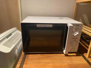 a microwave oven sitting on top of a table at 54Journey Roppongi in Tokyo