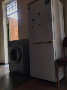 a refrigerator next to a washing machine in a room at Legenda Health Resort in Kaji-Say