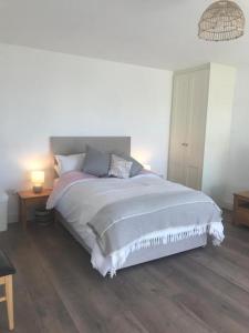 a bedroom with a large bed with two pillows at New studio near Lahinch, Doolin & Cliffs of Moher in Lahinch