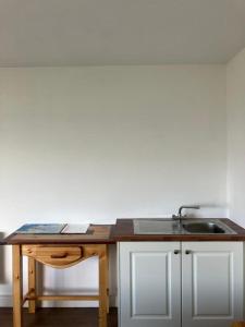 a kitchen with a sink and a wooden table at New studio near Lahinch, Doolin & Cliffs of Moher in Lahinch