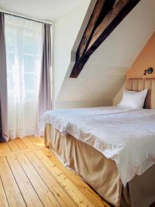 a bedroom with a bed and a large window at Rezidence Wannas Self Check in in Sigulda